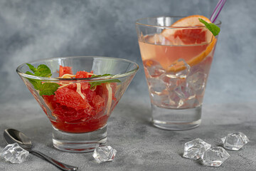 Summer salad with grapefruit on a light background with herbs.