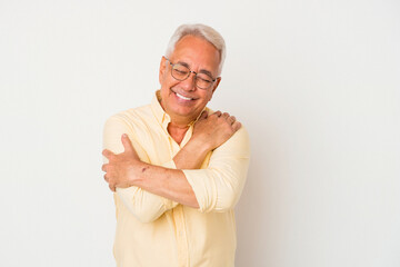 Senior american man isolated on white background hugs, smiling carefree and happy.