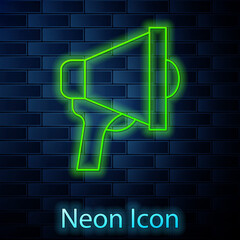 Glowing neon line Megaphone icon isolated on brick wall background. Speaker sign. Vector