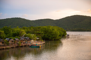 Fishing boats in a fishing village and mountains background, Ban Pak Nam Khaem Nu, Chanthaburi, Thailand.