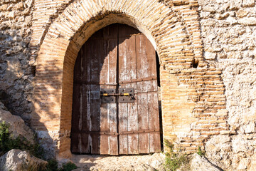 Wooden door at the entrance of the castle of Forna, Alicante (Spain). 