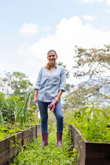 Fototapeta premium vertical shot of a woman standing in her orchard