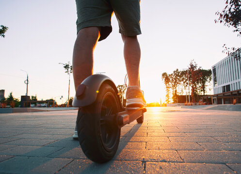 The Guy Riding The Electric Scooter In The Sunset