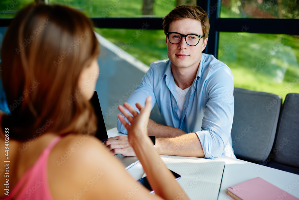 Poster back view portrait of skilled male student in classic spectacles for provide eyes protection looking