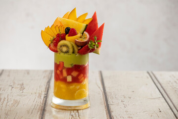 Fruit Avocado Cocktail cup on a wooden grungy table, Tropical fruits cocktail with avocado and honey.