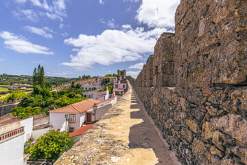 Fototapeta na wymiar Óbidos - June 29, 2021: Panoramic view of the medieval town of Óbidos, Portugal