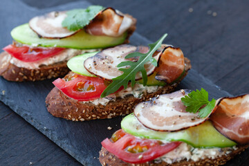Bruschetta with smoked bacon, tomato, cucumber and soft cheese