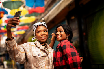Portrait of a happy smiling female friends. Women taking selfie photo.