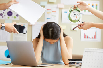 Portrait of beautiful business woman is stressed while working in the office because multitasking...