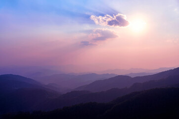 Sunset in the mountains of Northern Thailand. Mountains in the haze. Rainforest in the foreground. Doi Tung Mountain. Chiang Rai province. Thailand. Thai highlands
