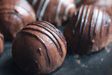 round shape dark chocolate on a plate on pink background 