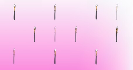 Composition of make up brush repeated on pink background