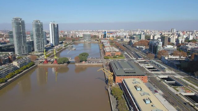 Aerial establishing shot of Puerto Madero's waterway with some buildings at sides