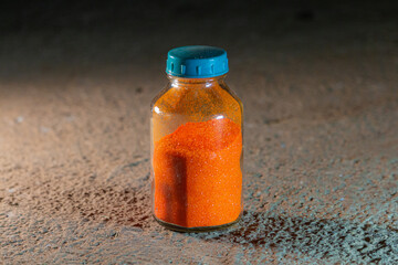 Orange poweder Ammonium dichromate in a glass bottle