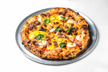 Whole cheese and minced meat pizza over white background.
