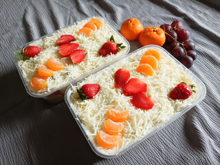 Plastic Container With Yummy Fruit Salad. Cheese, Strawbeery and Orange on Top. Selective Focus