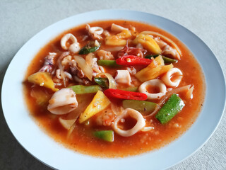 White Plate With Delicous Sweet and Sour Squid and Vegetables. Selective Focus