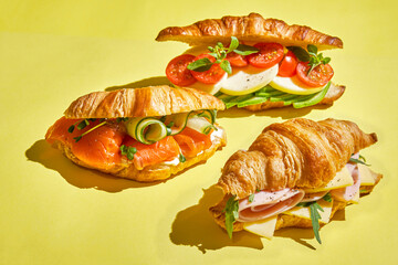 croissant sandwich with salmon, ham and cheese