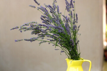 Yelow vase with fresh lavender flowers. Selective focus.