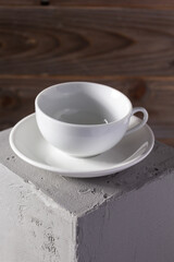 Empty cup of coffee on concrete grey cube as  background texture.  Abstract concept of break