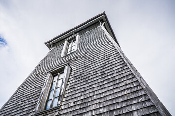 Close up view on the beautiful Pointe a la Renommée Lighthouse covered with shingles, one of the most famous lighthouse of Gaspesie, in Quebec (Canada)