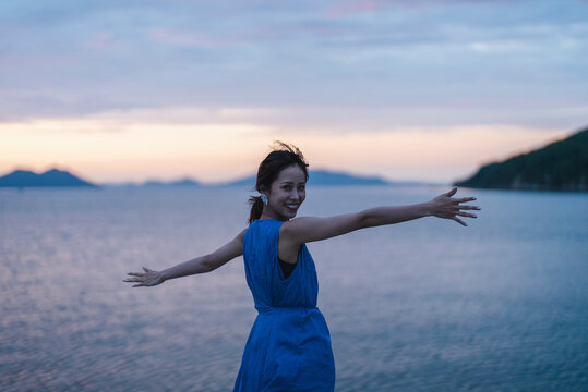 夕暮れの海にいる女性