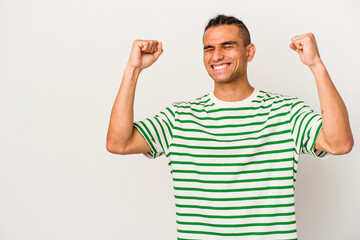 Young venezuelan man isolated on white background raising fist after a victory, winner concept.