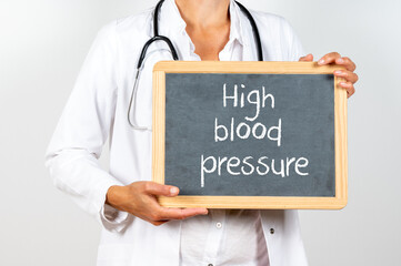 Doctor holding a blackboard with High blood pressure text