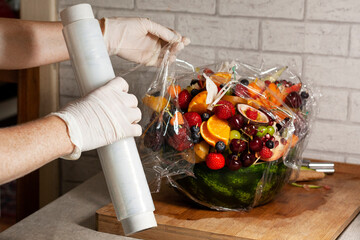 Person packing a carved watermelon