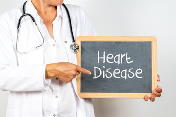 Doctor holding a blackboard with Heart Disease text