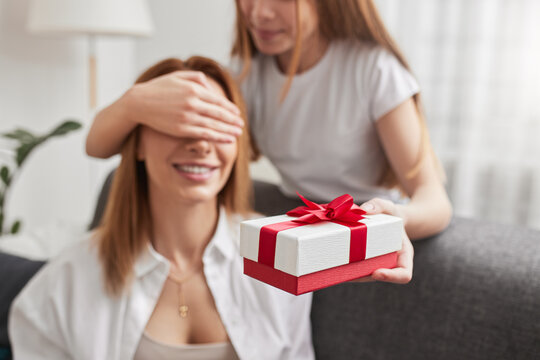 Daughter Giving Gift Box For Happy Mother