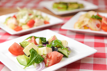 Greek salad with cheese, juicy tomatoes, red pepper, red onion, cucumber and lettuce.