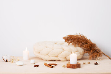 Home decoration with candles and flowers over white wall. Interior design concept. Close up, copy...