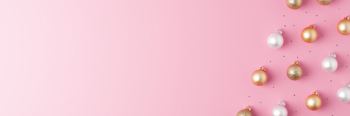 Christmas pink minimal background with grey and beige ball and confetti. Flat lay, copy space