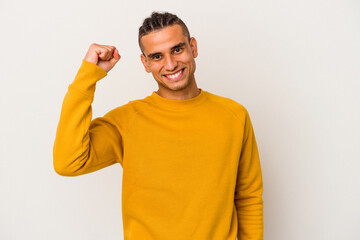 Young venezuelan man isolated on white background cheering carefree and excited. Victory concept.