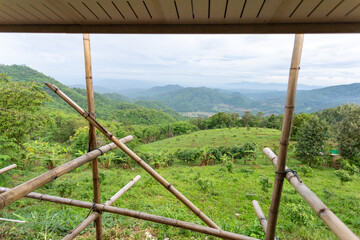 View of the landscape in front of the house that is being built, showing the bamboo frame. View of the front of the house on the top of the mountain see the beautiful sky mountains