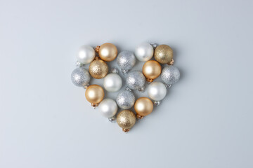 Christmas minimal composition with grey and beige balls on grey background. Flat lay, copy space