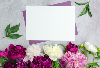Blank paper and peony flowers. Blank for a greeting card or invitation. Flower background