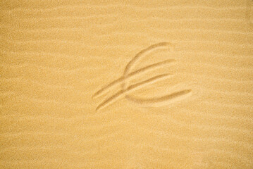 Euro Sign on Sand on Beach Holiday Background