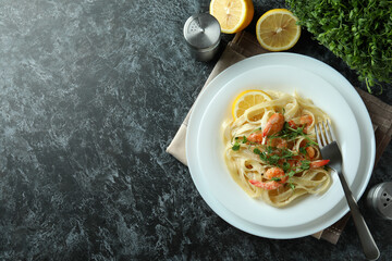 Concept of tasty eating with shrimp pasta on black smokey table