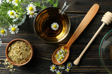 Concept of cooking chamomile tea on rustic wooden table