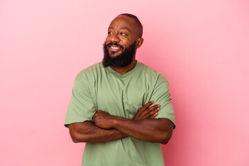 smiling confident with crossed arms.