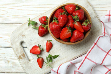 Concept of tasty eating with fresh strawberry on wooden table