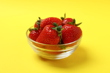 Fresh tasty strawberry on yellow background, close up
