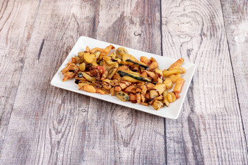 Assorted vegetable tempura tray are soy sauce on wooden table
