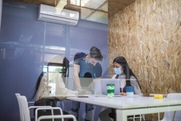 Group of diverse colleagues gathering at table during meeting