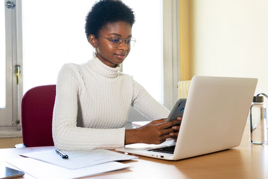 Doctor with laptop and smartphone working in office
