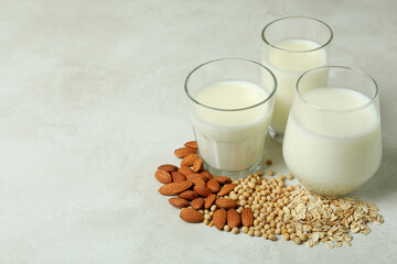 Concept of vegan milk on white textured background