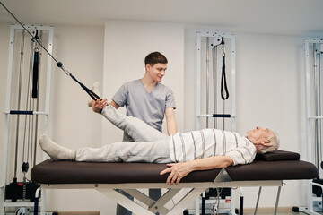 Person doing leg exercise with foot attached to resistance band