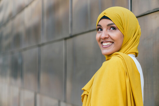 Stylish Muslim Woman In Yellow Headscarf In City